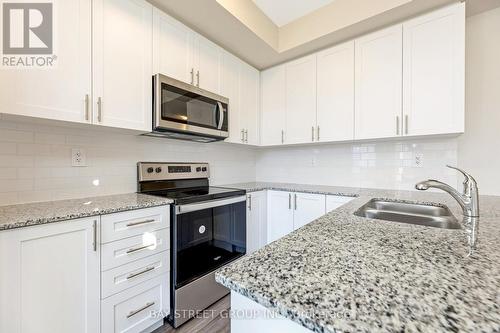 111 - 1573 Rose Way, Milton, ON - Indoor Photo Showing Kitchen With Double Sink With Upgraded Kitchen