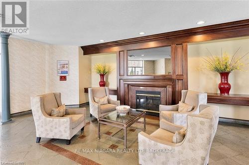 523 - 8111 Forest Glen Drive, Niagara Falls (208 - Mt. Carmel), ON - Indoor Photo Showing Living Room With Fireplace