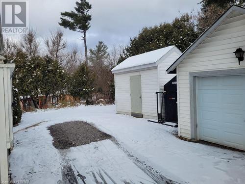 Snowy yard featuring an outdoor structure and a garage - 491 Mcconnell Street, Mattawa, ON - Outdoor With Exterior