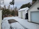 Snowy yard featuring an outdoor structure and a garage - 491 Mcconnell Street, Mattawa, ON  - Outdoor With Exterior 