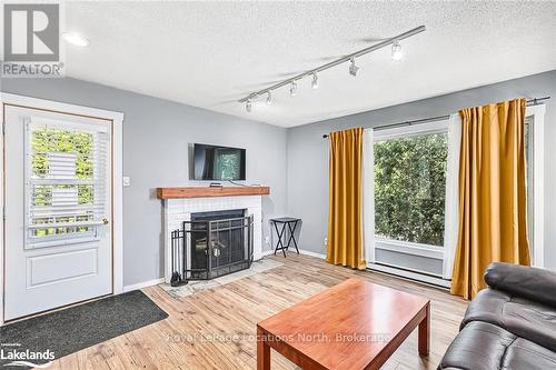 113 - 23 Dawson Drive, Collingwood, ON - Indoor Photo Showing Living Room With Fireplace