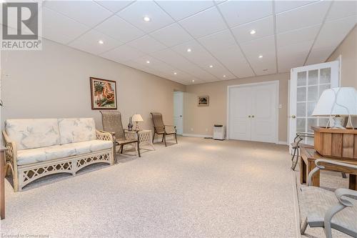 Living area featuring a drop ceiling and carpet floors - 64 Cottonwood Crescent, Cambridge, ON - Indoor