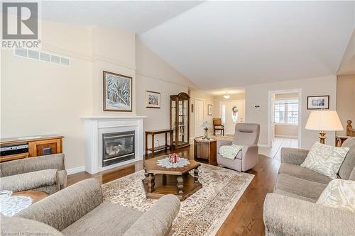 Living room featuring hardwood floors and lofted ceiling - 64 Cottonwood Crescent, Cambridge, ON - Indoor Photo Showing Living Room With Fireplace