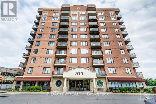 101 - 314 Central Park Drive, Ottawa, ON - Outdoor With Balcony With Facade