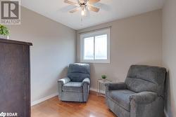 Living area featuring a textured ceiling, light hardwood / wood-style flooring, and ceiling fan - 