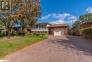 Split level home featuring a front yard and a garage - 47 Westfield Drive, St. Catharines, ON  - Outdoor With Facade 