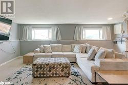 Living room featuring a textured ceiling, carpet floors, and a healthy amount of sunlight - 