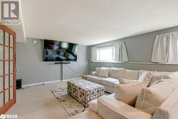 Living room with carpet flooring and a textured ceiling - 