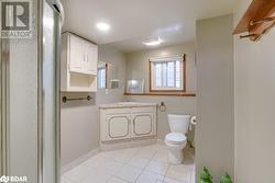 Bathroom featuring tile patterned floors, vanity, and toilet - 