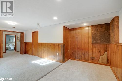 Empty room featuring wooden walls and carpet - 47 Westfield Drive, St. Catharines, ON - Indoor Photo Showing Other Room