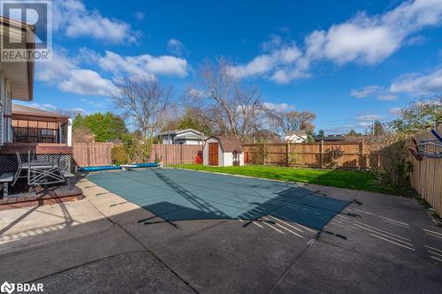 View of swimming pool with a yard, a patio, and a storage unit - 47 Westfield Drive, St. Catharines, ON - Outdoor With Backyard