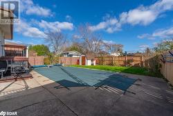 View of swimming pool with a yard, a patio, and a storage unit - 