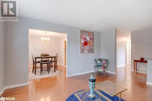 Living area with wood-type flooring and a notable chandelier - 47 Westfield Drive, St. Catharines, ON - Indoor