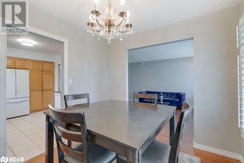 Dining space with a chandelier and light wood-type flooring - 47 Westfield Drive, St. Catharines, ON - Indoor Photo Showing Dining Room