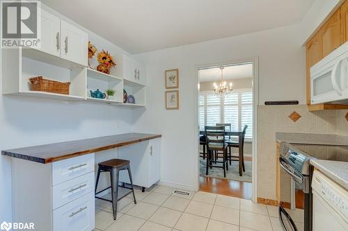 Kitchen featuring a chandelier, white appliances, white cabinetry, and hanging light fixtures - 47 Westfield Drive, St. Catharines, ON - Indoor