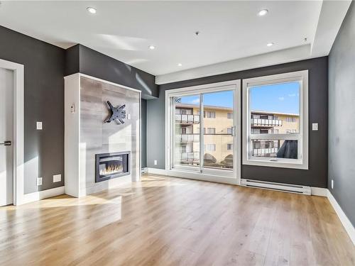 203-835 Dunsmuir Rd, Esquimalt, BC - Indoor Photo Showing Living Room With Fireplace