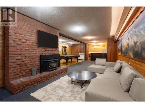 rec room lower level with fireplace - 1557 Nichol Road, Revelstoke, BC - Indoor Photo Showing Living Room With Fireplace