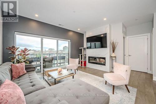 608 - 71 Wyndham Street S, Guelph, ON - Indoor Photo Showing Living Room With Fireplace