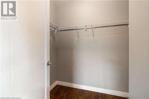 Walk in closet featuring hardwood / wood-style floors - 112 King Street E Unit# 305, Hamilton, ON - Indoor With Storage