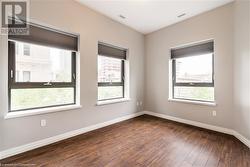 Empty room featuring dark wood-type flooring - 