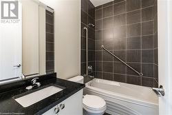 Full bathroom with vanity, toilet, and tiled shower / bath - 