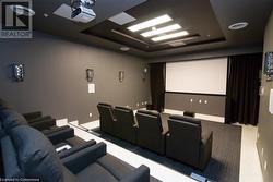 Home theater room with a raised ceiling - 