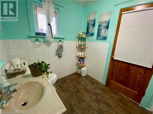 Bathroom featuring toilet, sink, and tile walls - 507 Victoria Street N Unit# 2, Kitchener, ON - Indoor Photo Showing Bathroom