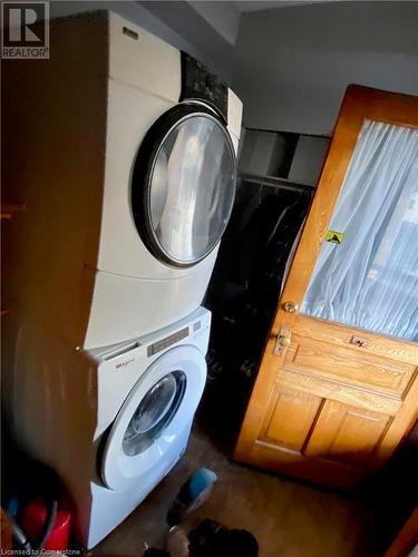 Clothes washing area featuring stacked washing maching and dryer - 507 Victoria Street N Unit# 2, Kitchener, ON - Indoor Photo Showing Laundry Room