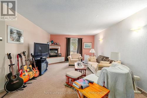 1 - 891 River Road W, Wasaga Beach, ON - Indoor Photo Showing Living Room With Fireplace