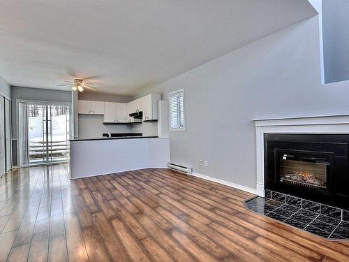 Living room - A-222 Rue Sandy, Sainte-Sophie, QC - Indoor Photo Showing Living Room With Fireplace