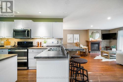 84 Wasaga Sands Drive, Wasaga Beach, ON - Indoor Photo Showing Kitchen With Fireplace