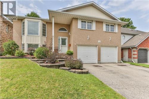 View of front of house with a front yard and a garage - 46 Hodgins Crescent, Woodstock, ON - Outdoor With Facade