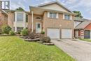 View of front of house with a front yard and a garage - 46 Hodgins Crescent, Woodstock, ON  - Outdoor With Facade 