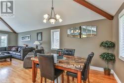 Dining space featuring vaulted ceiling with beams - 