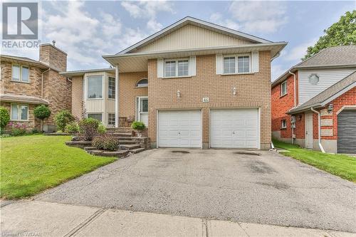 View of front of property with a front yard and a garage - 46 Hodgins Crescent, Woodstock, ON - Outdoor With Facade