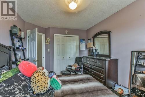 Bedroom with ceiling fan, a textured ceiling, and a closet - 46 Hodgins Crescent, Woodstock, ON - Indoor