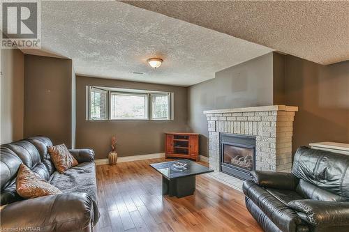 Family room featuring a fireplace - 46 Hodgins Crescent, Woodstock, ON - Indoor Photo Showing Living Room With Fireplace