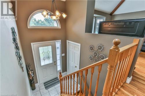 Foyer with vaulted ceiling with beams, a notable chandelier, and light wood-type flooring - 46 Hodgins Crescent, Woodstock, ON - Indoor Photo Showing Other Room