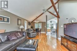 Living room featuring beamed ceiling, high vaulted ceiling - 