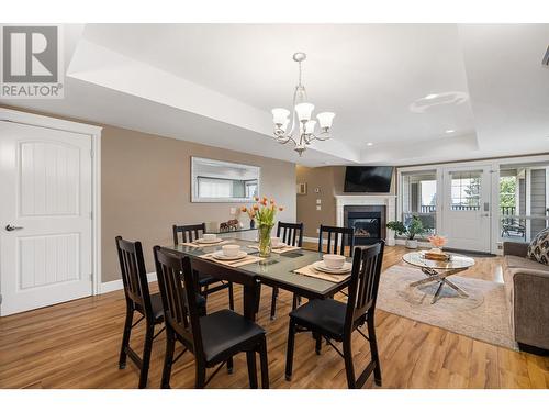 374 Trumpeter Court, Kelowna, BC - Indoor Photo Showing Dining Room With Fireplace