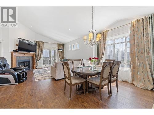 374 Trumpeter Court, Kelowna, BC - Indoor Photo Showing Dining Room With Fireplace