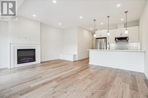 2 - 29 Cyclone Way, Fort Erie (337 - Crystal Beach), ON - Indoor Photo Showing Kitchen With Fireplace With Upgraded Kitchen