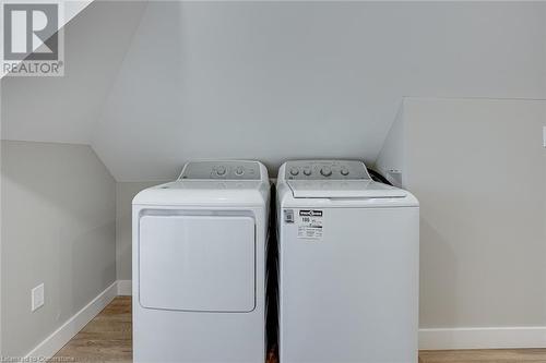 Clothes washing area with light wood-type flooring and washer and clothes dryer - 102 Wellington Street N Unit# 4, Hamilton, ON - Indoor Photo Showing Laundry Room