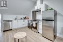 Kitchen with white cabinets, appliances with stainless steel finishes, and decorative backsplash - 102 Wellington Street N Unit# 4, Hamilton, ON  - Indoor Photo Showing Kitchen 