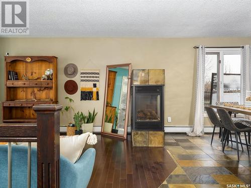 122 Hawkes Bay, Regina, SK - Indoor Photo Showing Dining Room With Fireplace