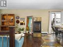 122 Hawkes Bay, Regina, SK  - Indoor Photo Showing Dining Room With Fireplace 