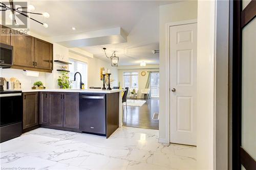 Kitchen featuring decorative light fixtures, kitchen peninsula, appliances with stainless steel finishes, and an inviting chandelier - 350 Dundas Street S Unit# 30, Cambridge, ON - Indoor Photo Showing Kitchen