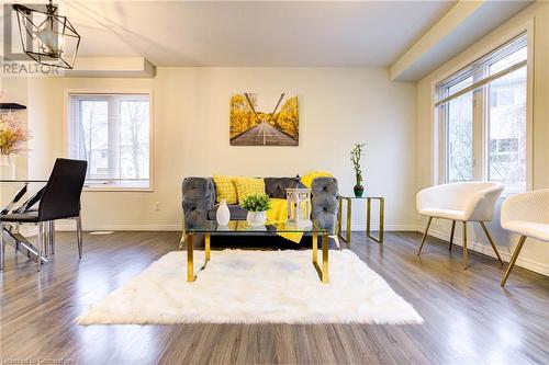 Sitting room with dark hardwood / wood-style floors, a wealth of natural light, and a notable chandelier - 350 Dundas Street S Unit# 30, Cambridge, ON - Indoor Photo Showing Dining Room