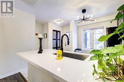 Kitchen featuring sink, a notable chandelier, and hardwood / wood-style flooring - 