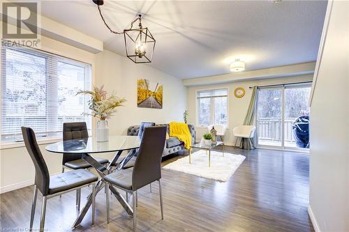 Dining room with a chandelier, a textured ceiling, dark hardwood / wood-style floors, and a healthy amount of sunlight - 350 Dundas Street S Unit# 30, Cambridge, ON - Indoor Photo Showing Dining Room